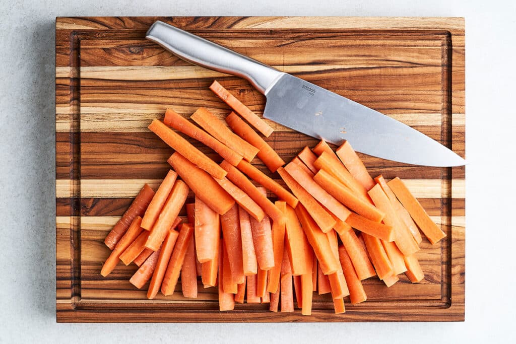 Cutting carrots into fries.