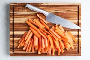 Cutting carrots into fries.