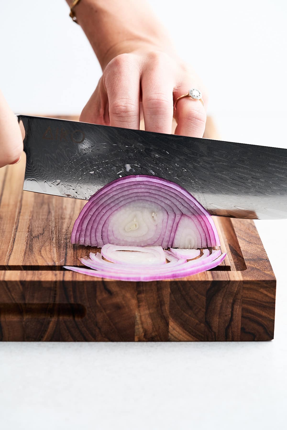 Nakiri knife slicing an onion.