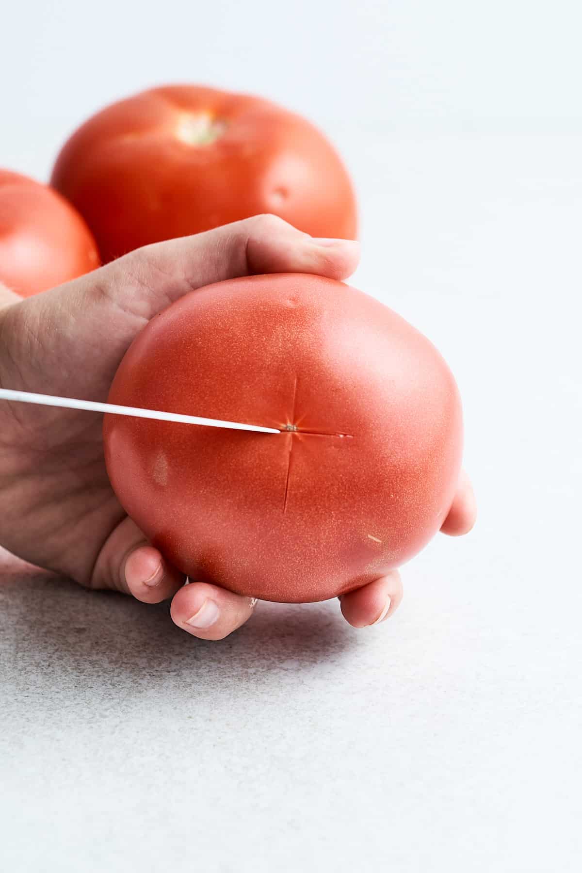 Scoring a tomato.