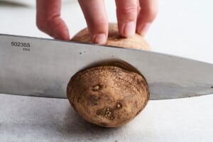 Cutting potatoes into hasselback.