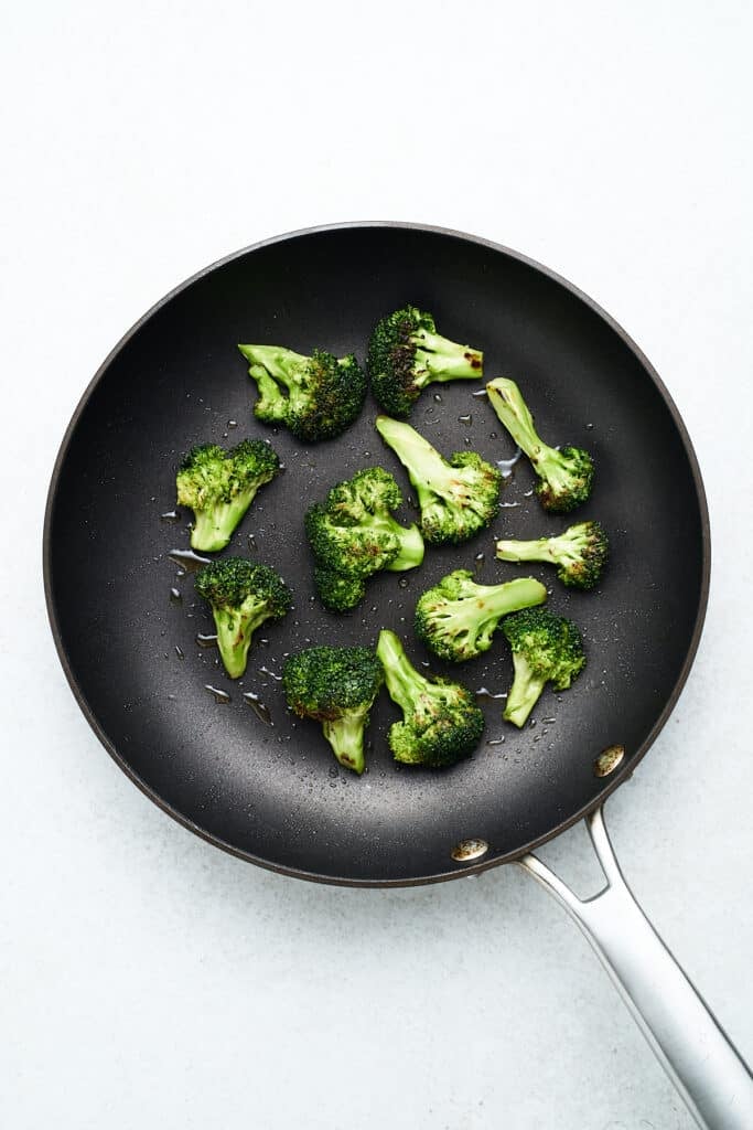 Sautéed broccoli in a skillet.