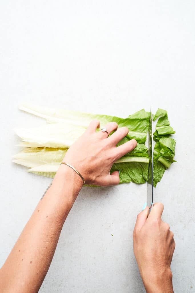 Slicing romaine lettuce into strips.