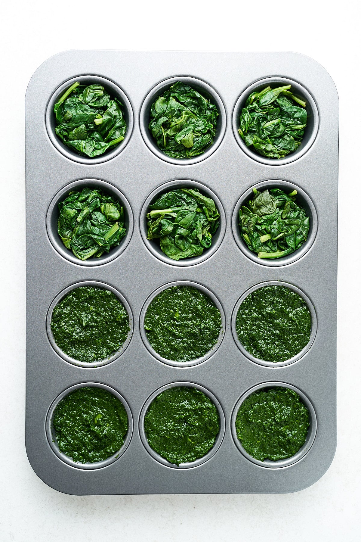 Pureed and blanched spinach in muffin cups.