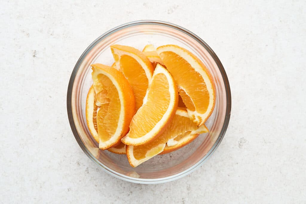 Cut oranges in a glass container.