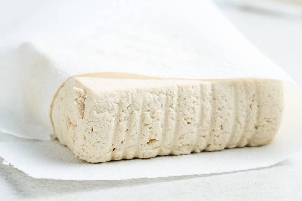Tofu wrapped in paper towel.