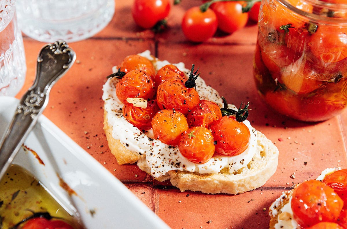 Tomato confit on toast with ricotta cheese.