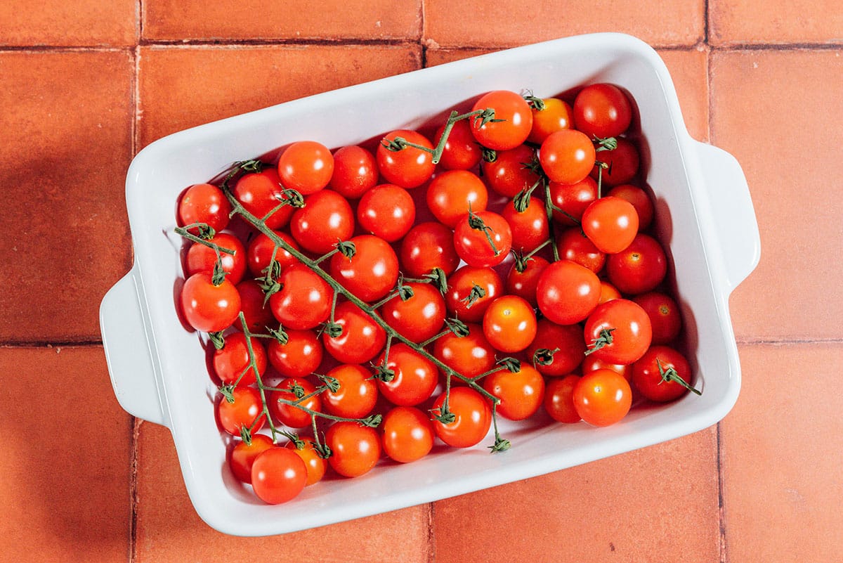 Cherry tomatoes in a white baking dish.