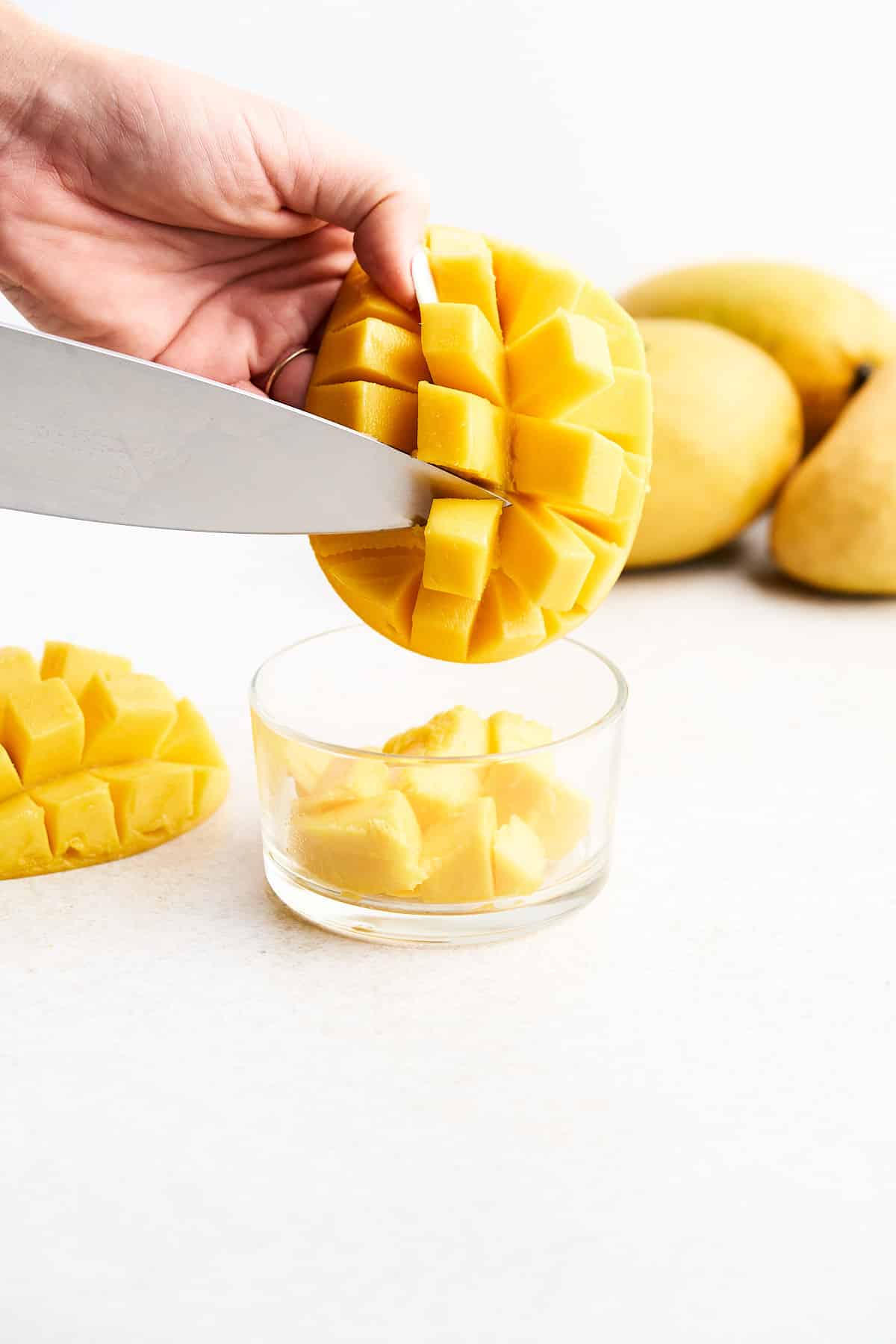 Cutting cubes off a mango.