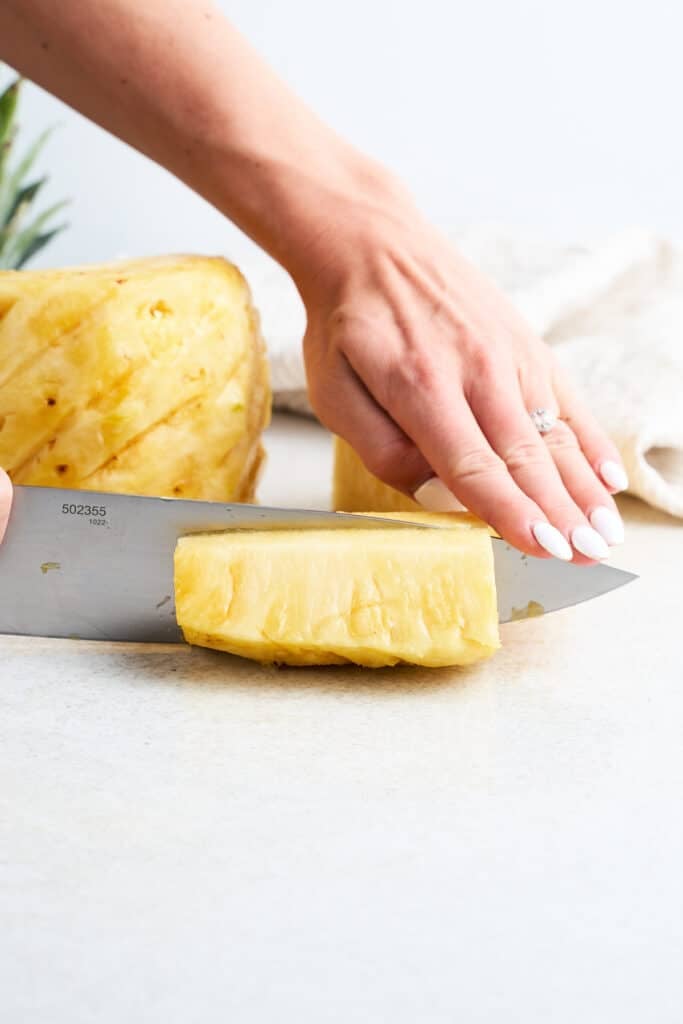 Cutting a pineapple into eighths.