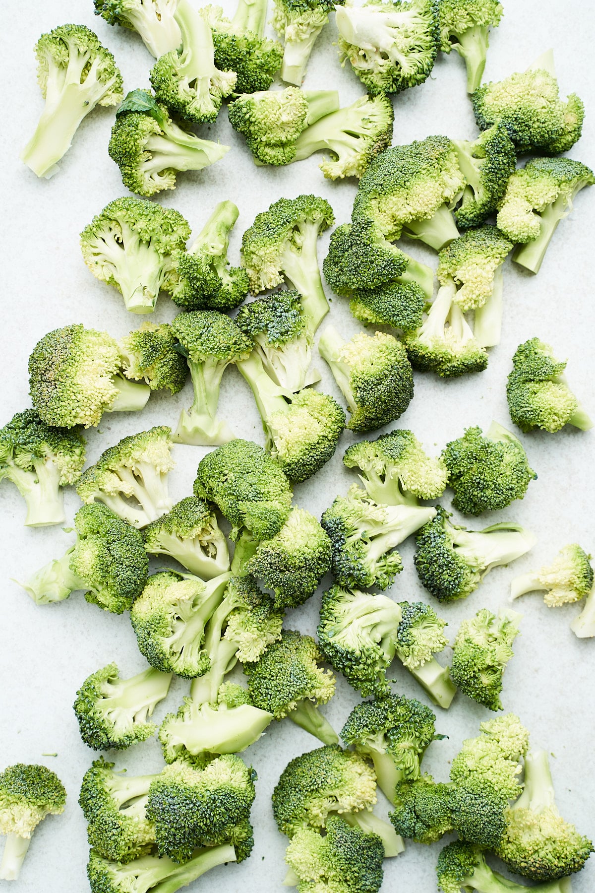 Frozen broccoli on a baking tray.