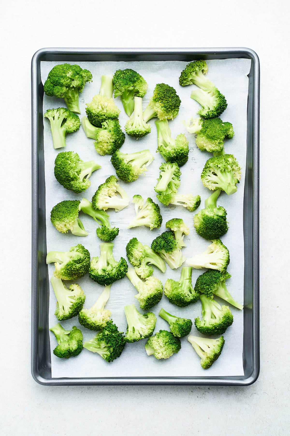 Frozen broccoli on a baking tray.