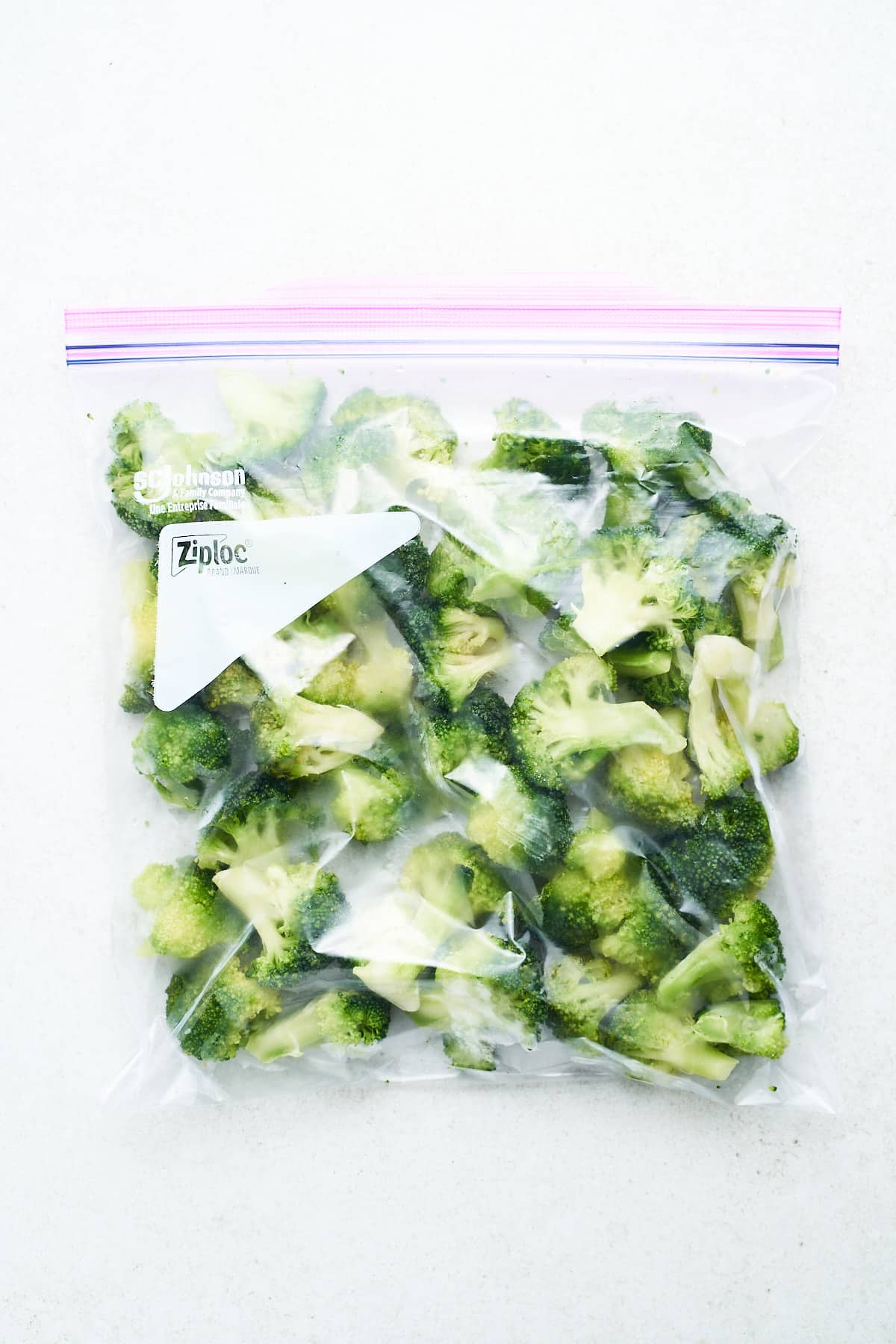 Frozen broccoli in a freezer bag.
