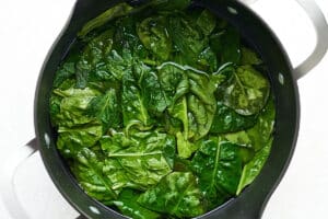 Freezing spinach by blanching it.