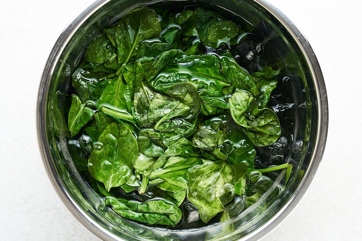 Freezing spinach by blanching it.
