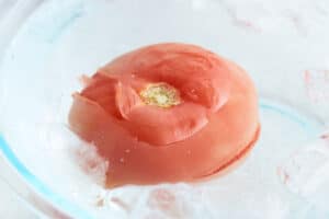 Putting a tomato in an ice bath.