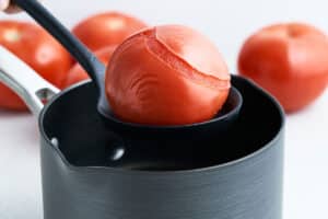 Parboiling a tomato.