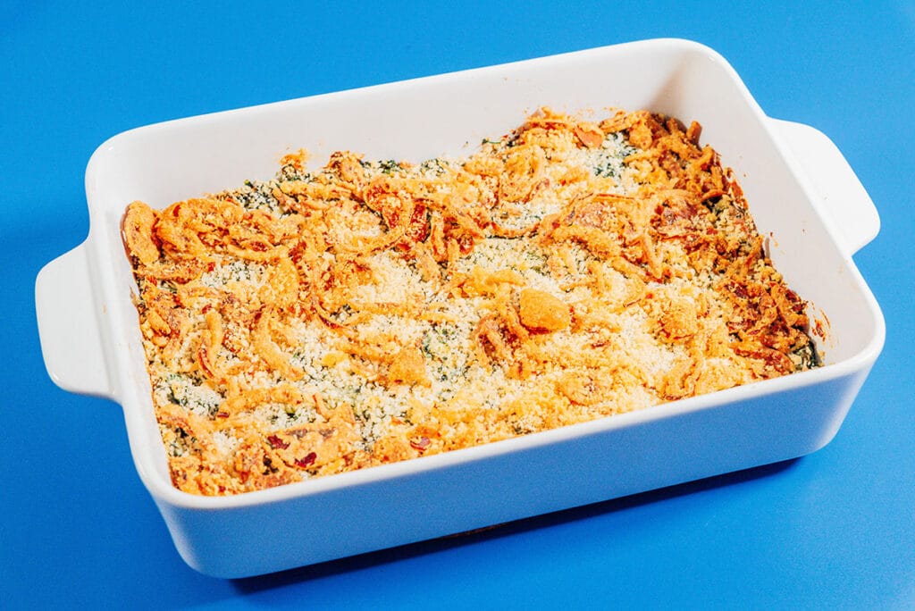 Spinach casserole in a white baking sheet.