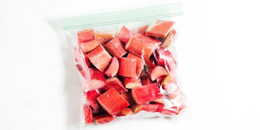 Frozen rhubarb in a bag on white background.
