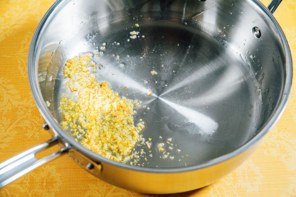 Browning garlic in a pan.