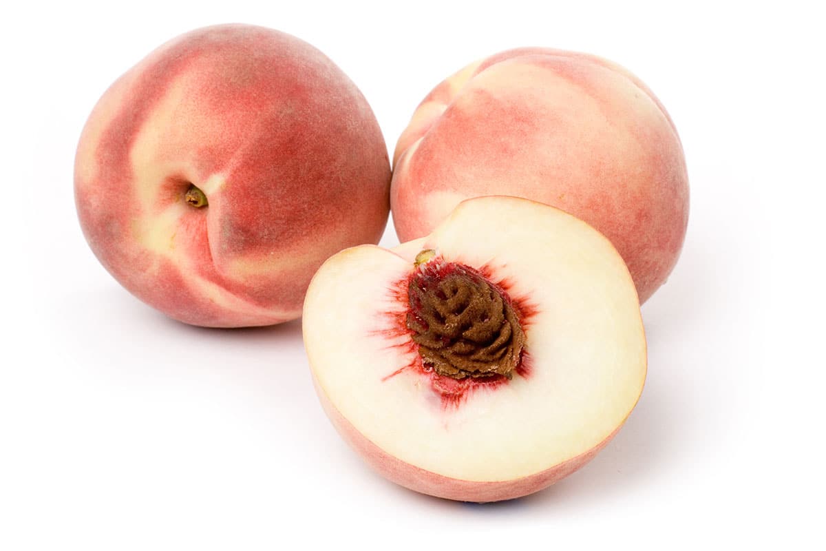 White peach cut in half.