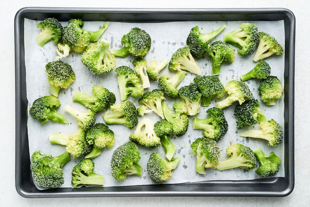 Freezing broccoli on a baking sheet.