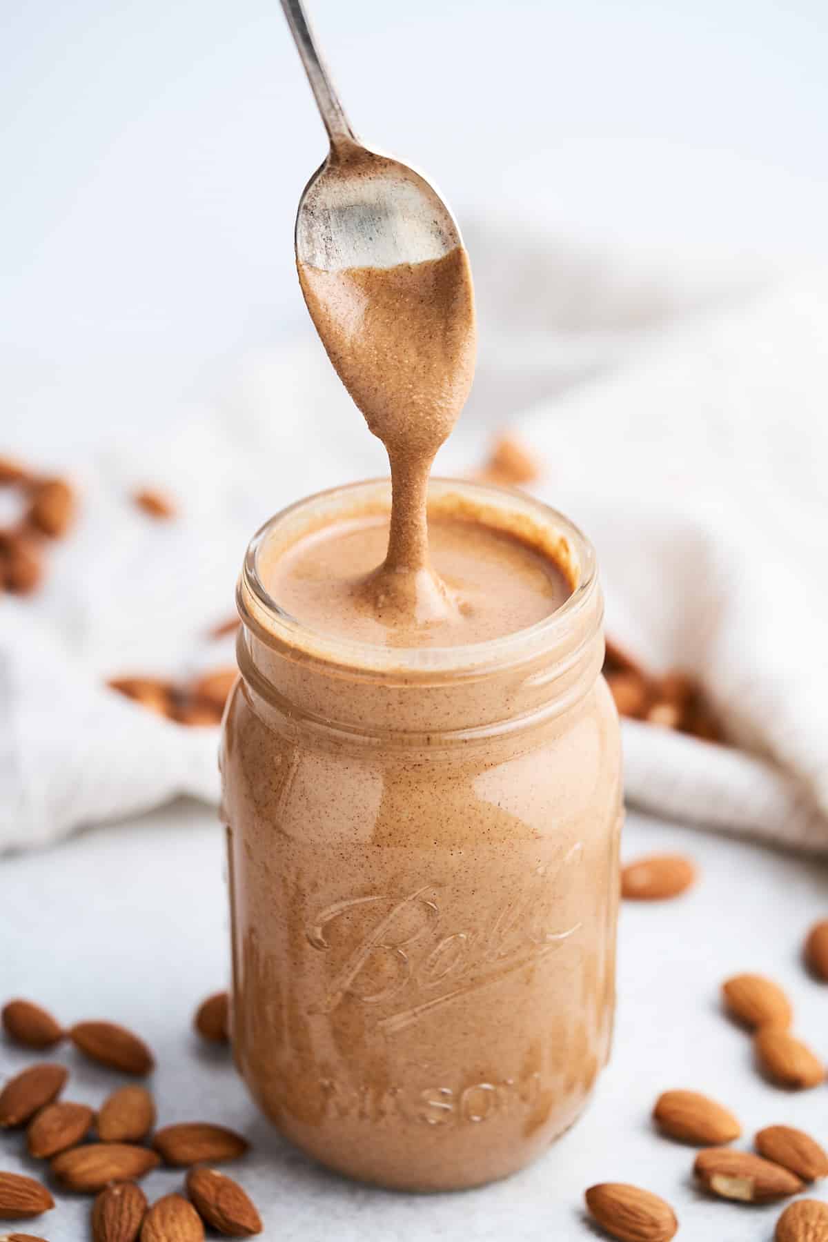 Almond butter dripping from a spoon.