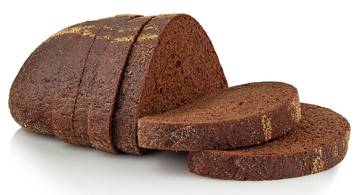 Sliced rye bread on white background.