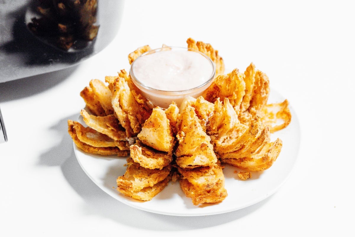 Air fryer bloomin onion on a white plate.