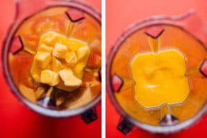 Frozen mango margarita slush in a glass with a slice of lime on a red background.