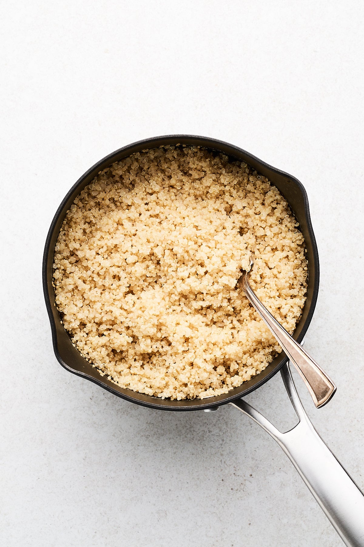 Fluffed quinoa in a pot.