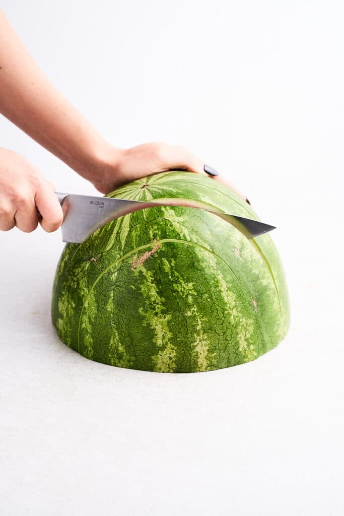 Slicing a watermelon into slabs.