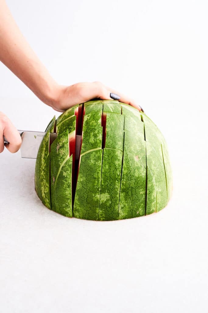 Cutting a watermelon into sticks.