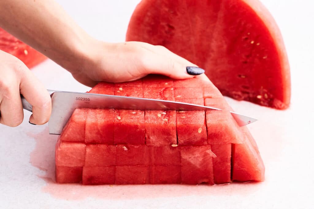 Cutting watermelon cubes.
