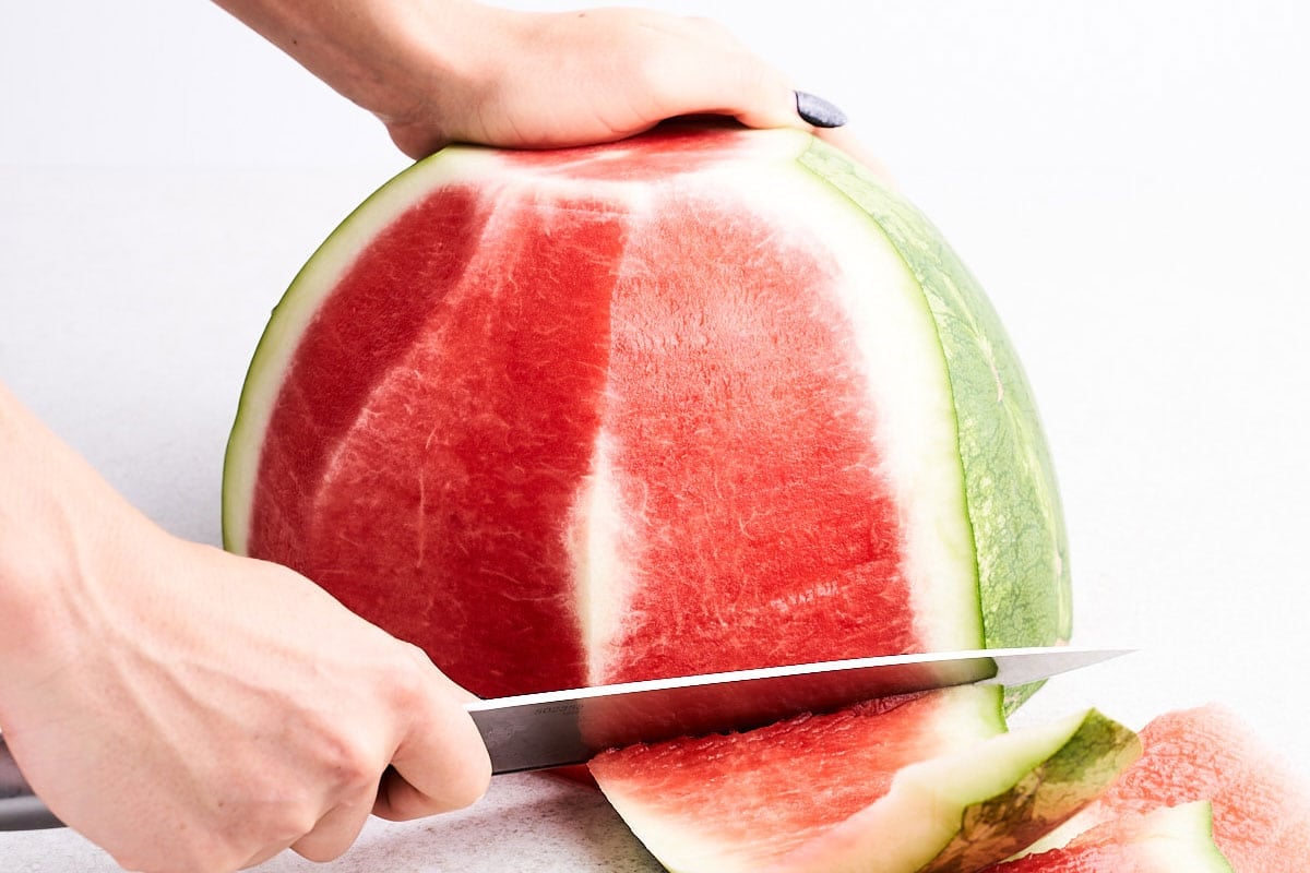 Cutting watermelon peel off.