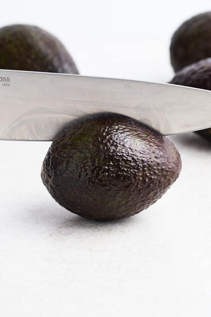 Slicing open an avocado.
