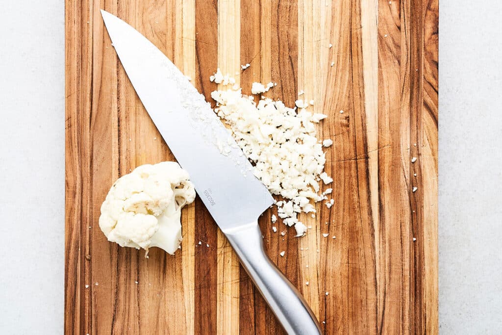 Making cauliflower rice with a knife.