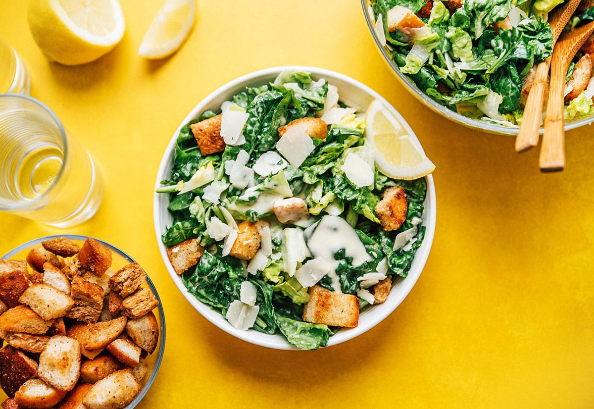 Caesar salad in a bowl with croutons, romaine lettuce, and parmesan