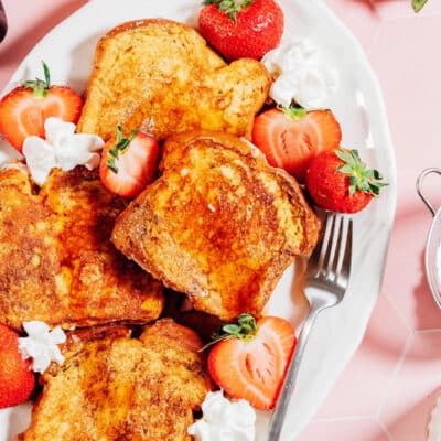 Stuffed French toast on a platter with strawberries.