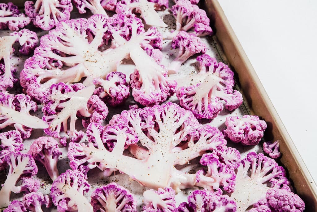 Roasted purple cauliflower on a pan.