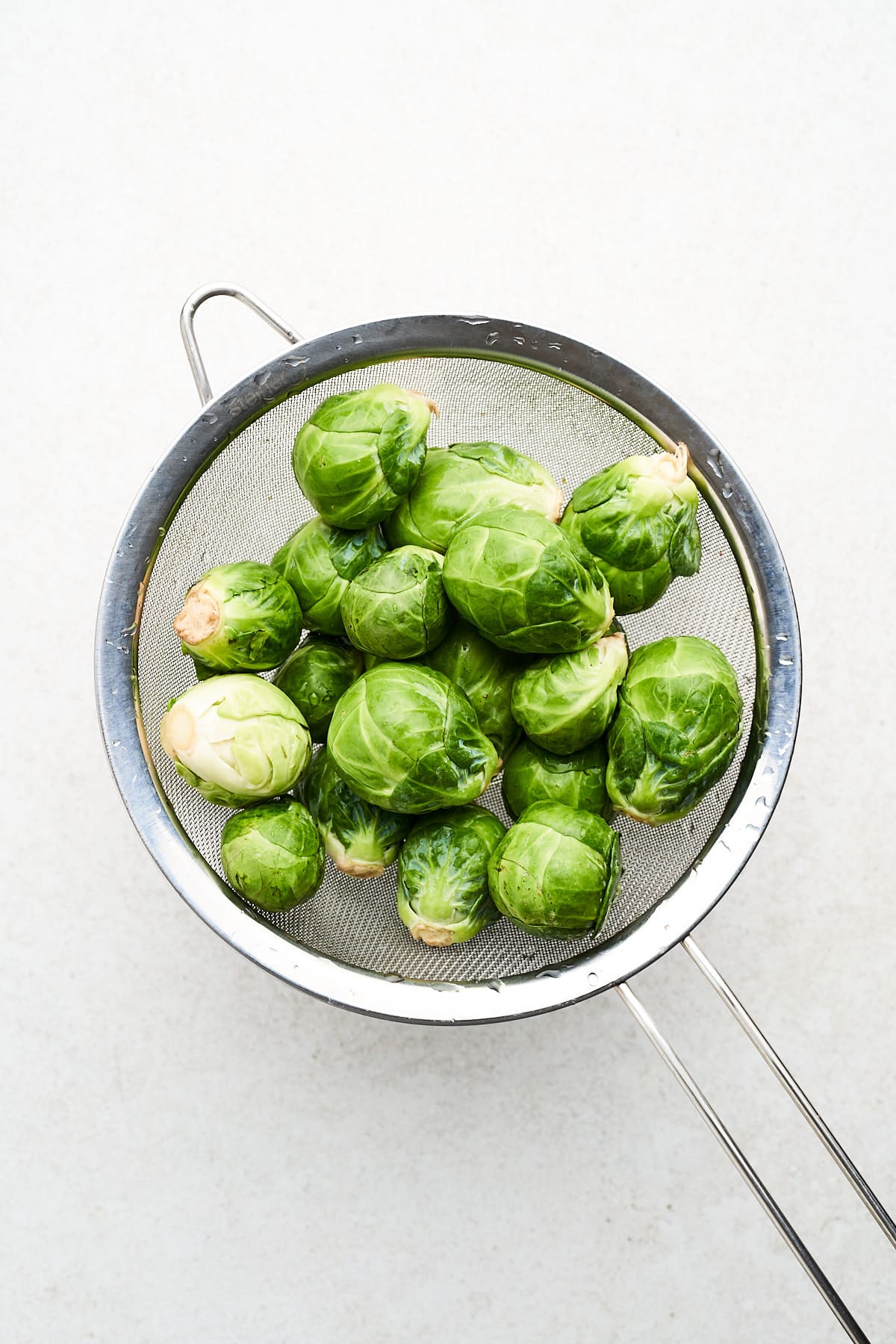 Brussels sprouts in a strainer.