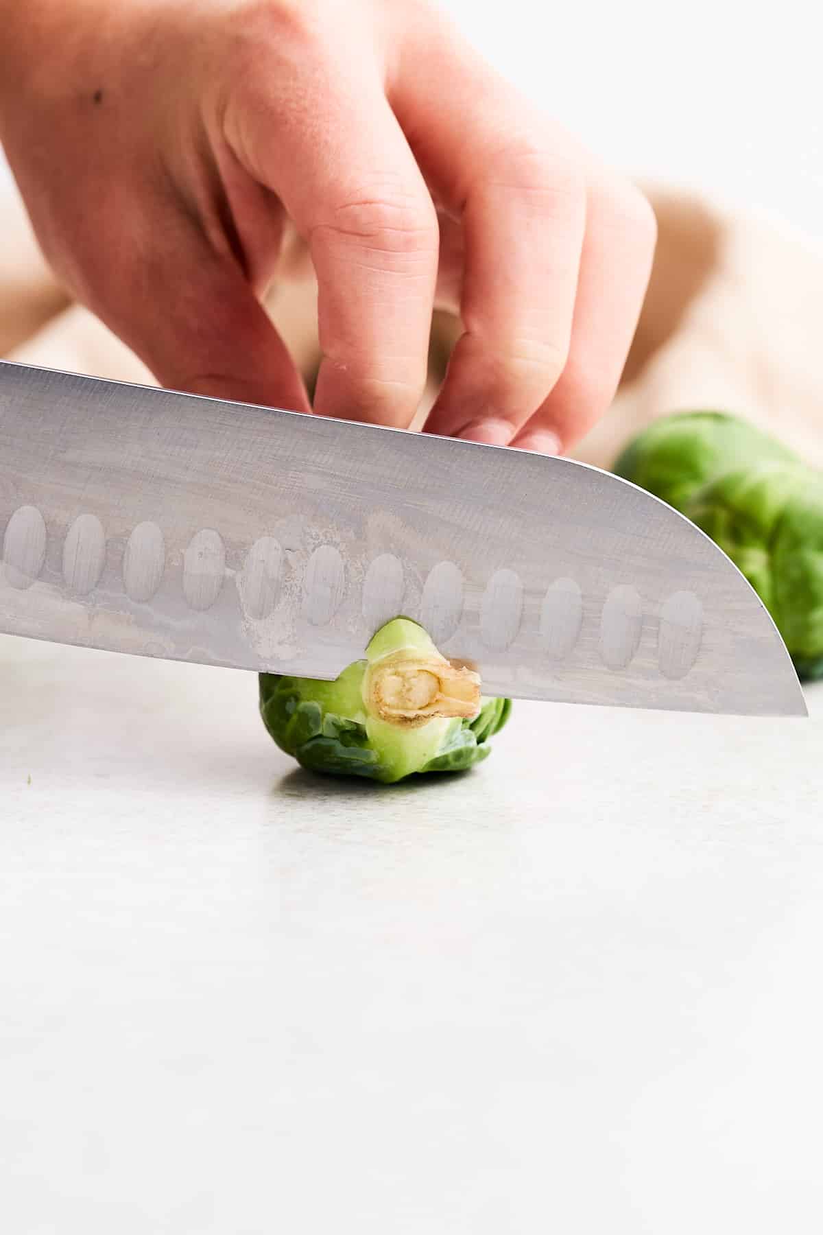 Chopping the end off of a Brussels sprout.