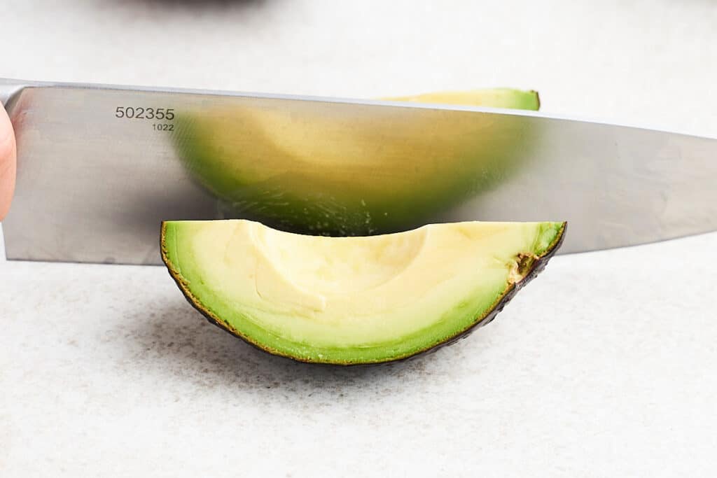 Quartering an avocado.