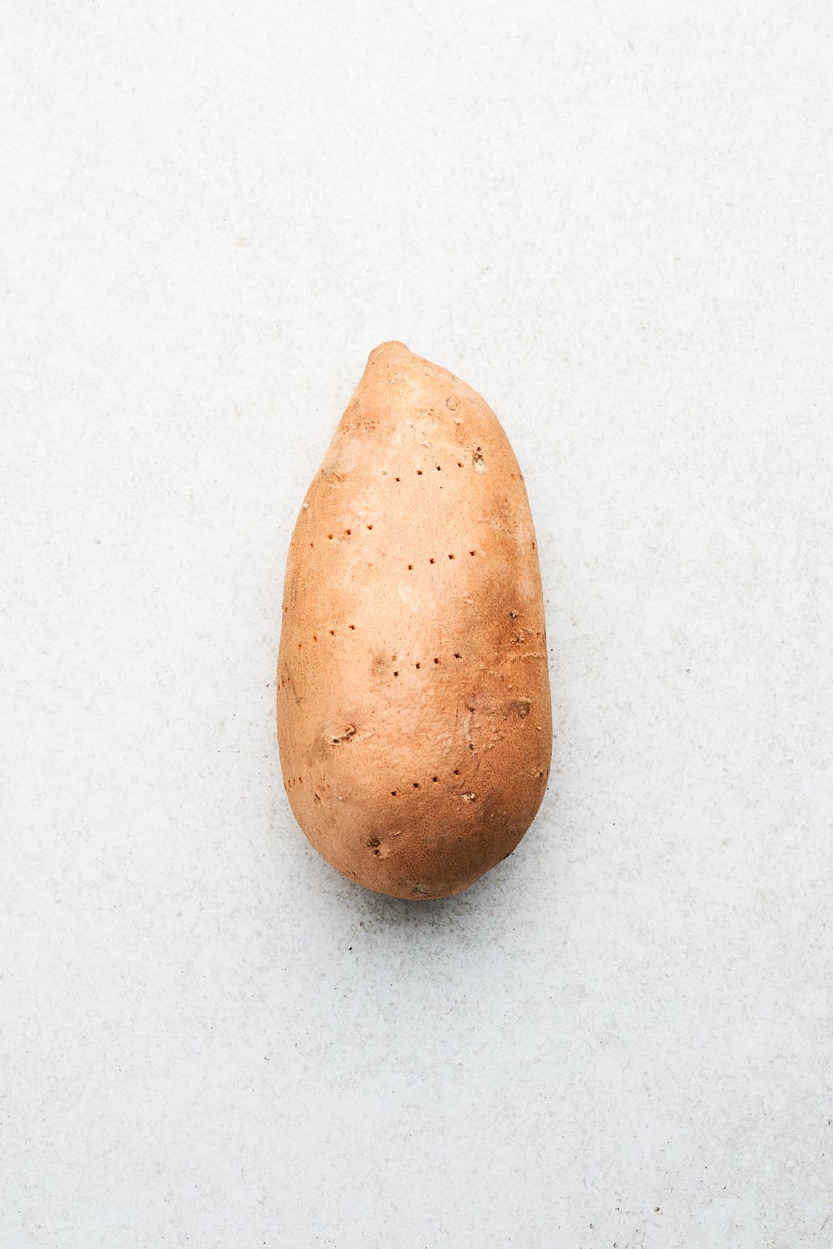 Sweet potato with fork pricks.