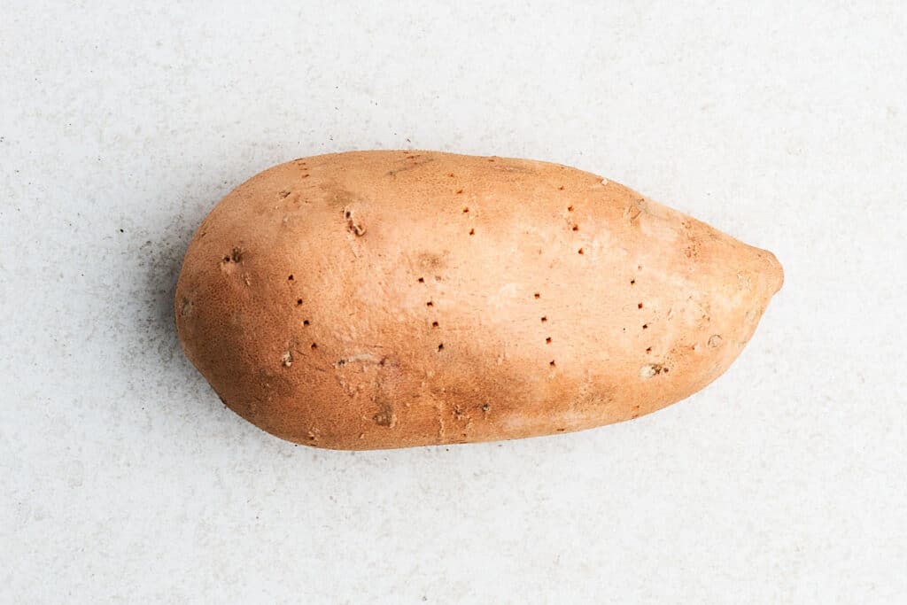 Sweet potato pricked with fork.