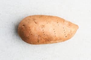 Sweet potato pricked with fork.