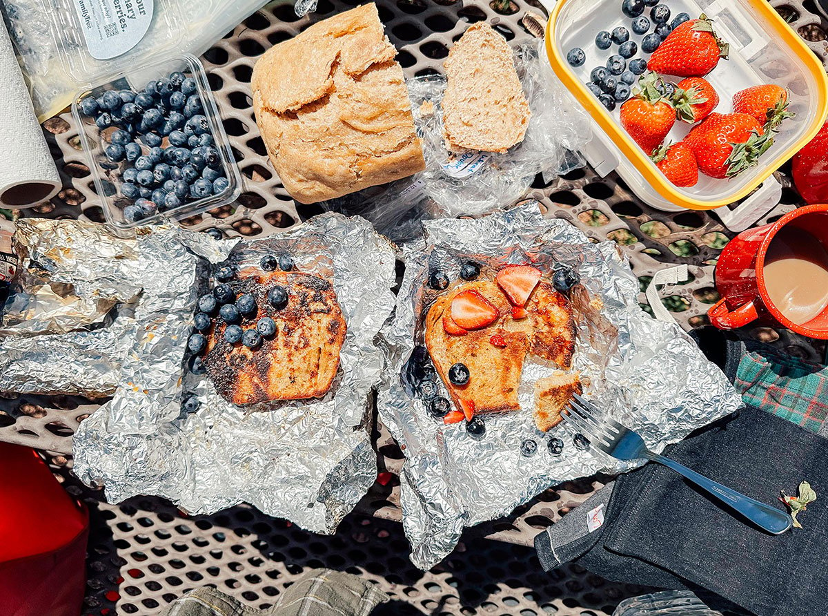 Campfire French toast in aluminum foil with berries.