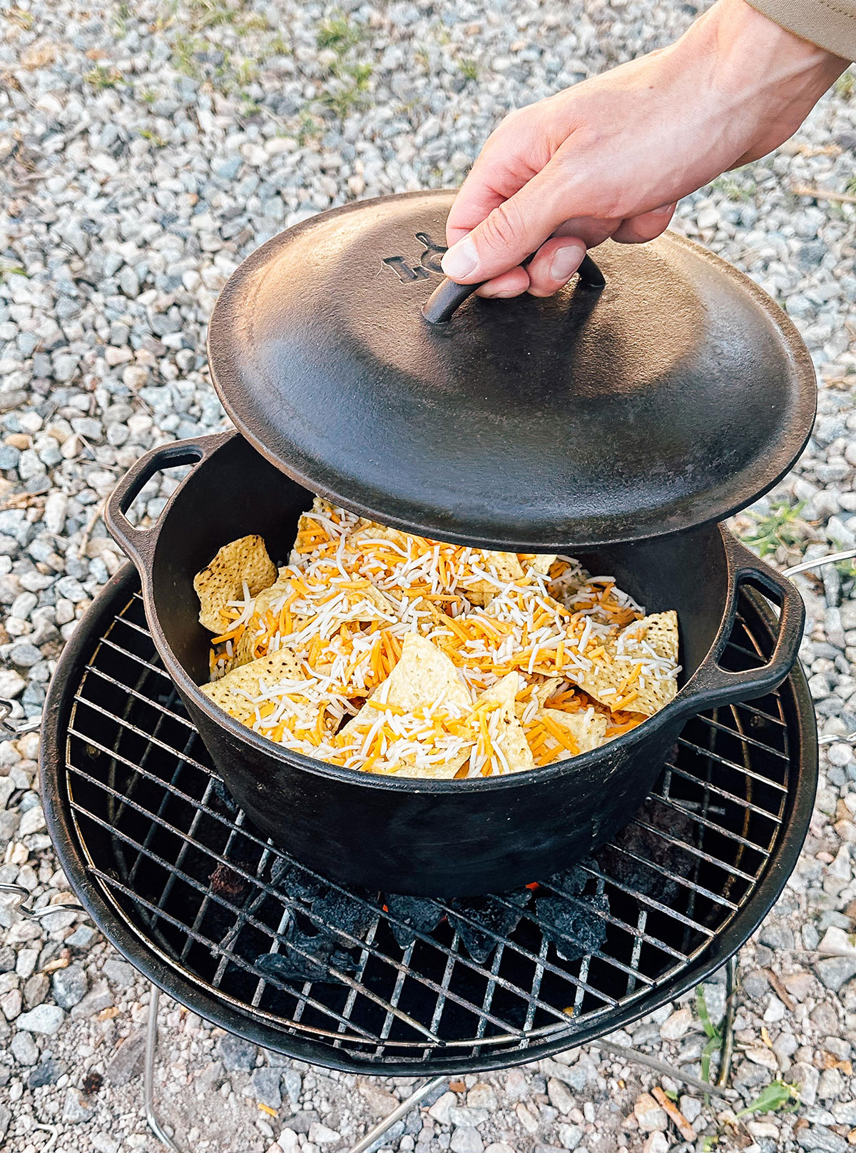 Chips and cheese in a Dutch oven over a coal stove.