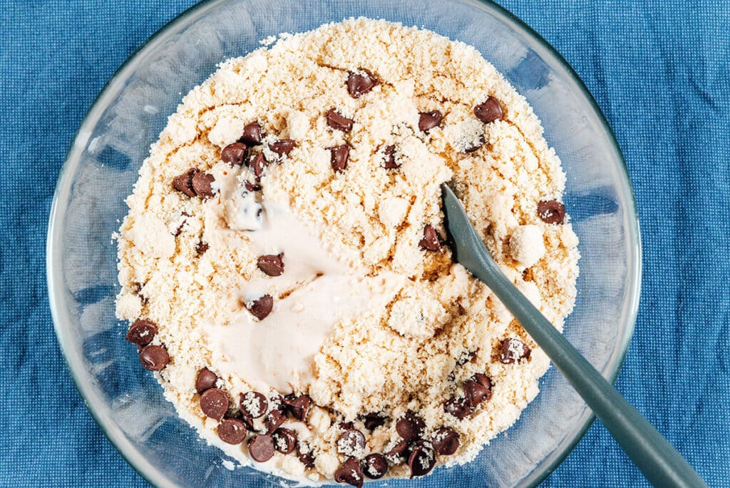 Mixing cottage cheese with almond meal and chocolate chips.