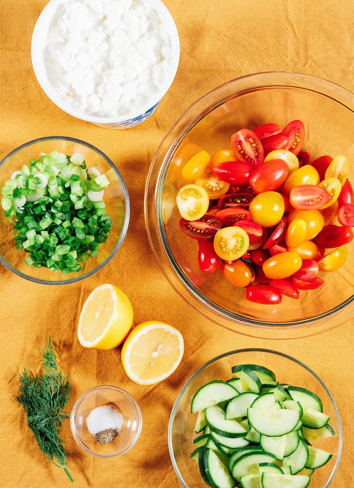 Ingredients to make cottage cheese salad on a yellow tablecloth.